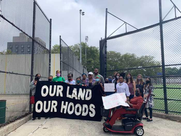 People stand with signs against National Grid and the North Brooklyn Pipeline