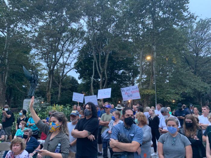 Greenpoint residents hold signs against a new homeless shelter on Apollo Street