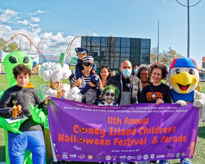 people in costume on the coney island boardwalk for halloween