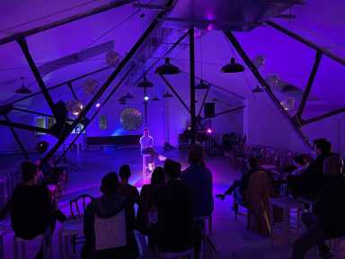 people watch a performance at super secret arts