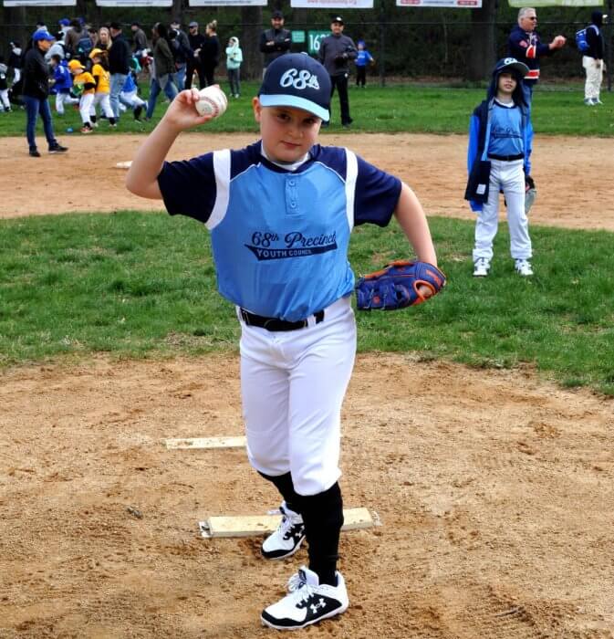 young baseball pitcher playing as youth sports resume