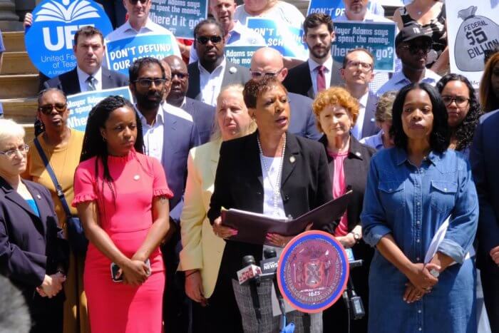 councilmembers rally about school budget cuts on city hall steps