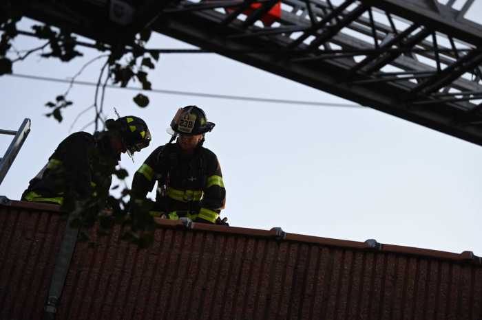 firefighters on the roof of building at two-alarm fire