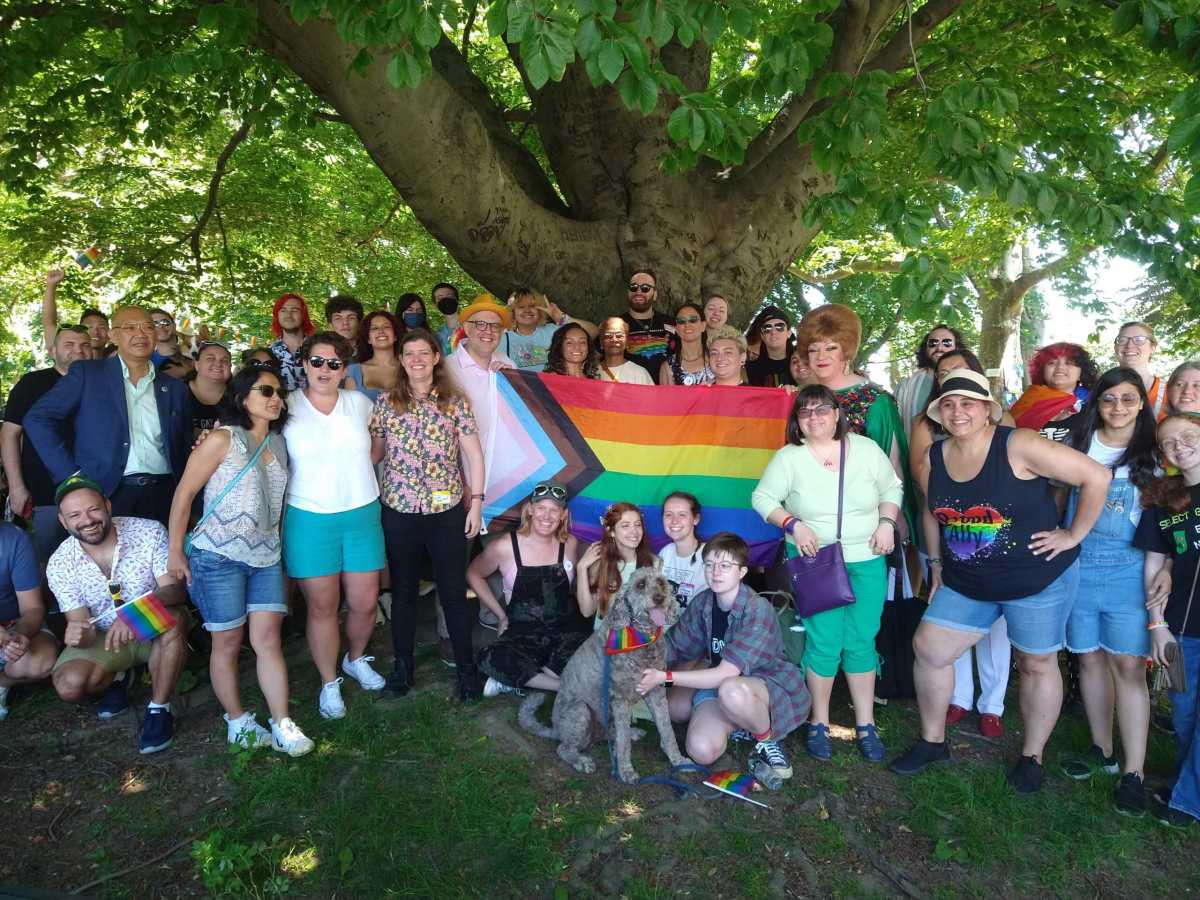 crowd of people with a pride flag at GayRidge