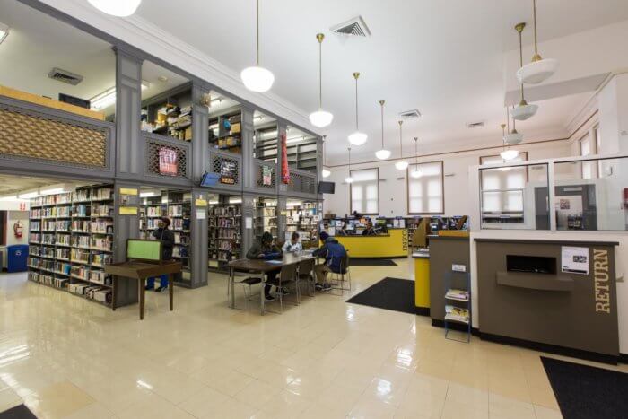 interior of people and desks at walt whitman library in fort greene