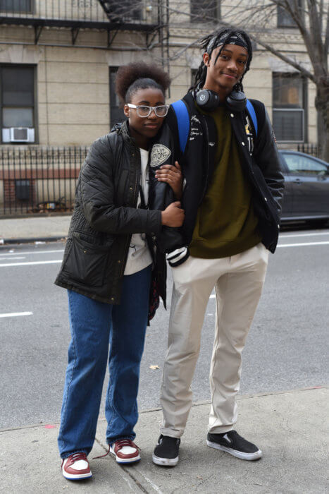 two younger people pose for a portrait