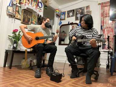 brooklyn musician sean fentress plays guitar with a pediatric hospice patient