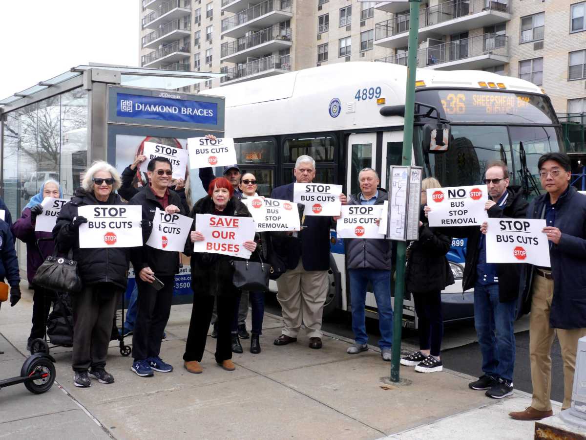 Protestors gather and hold signs outside of a bus stop in Sheepshead Bay. 3/2/2023