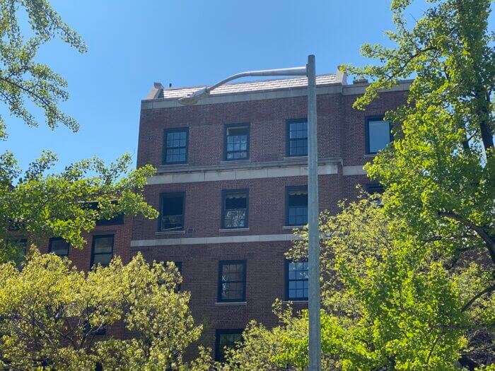 The windows on the fifth floor were smashed, and the brick facade was covered in black fire remnants.