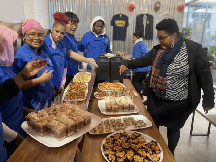 Students from the Brooklyn STEAM Center will serve up some warm dishes during the holiday experience.