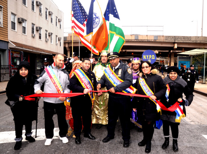 group of people cutting ribbon at three kings day parade