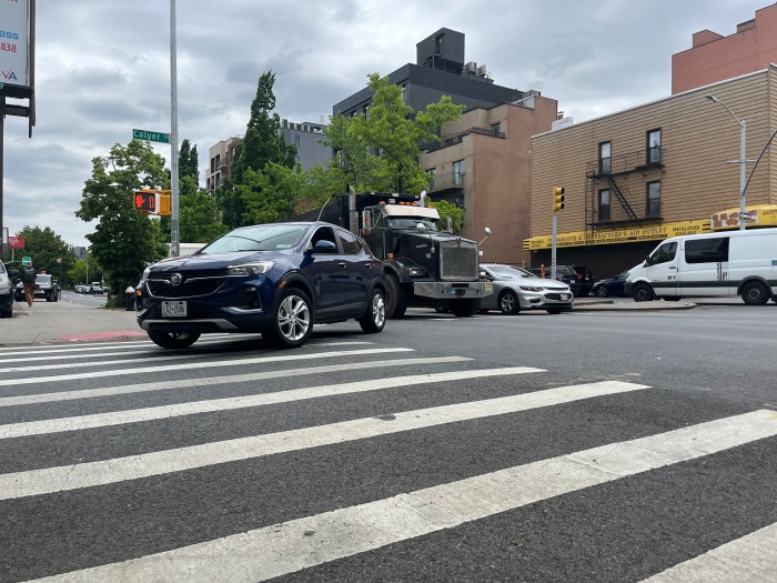 car turning on mcguinness boulevard