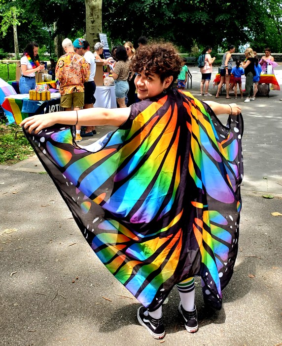 child posing in rainbow butterfly outfit at GayRidge Pride