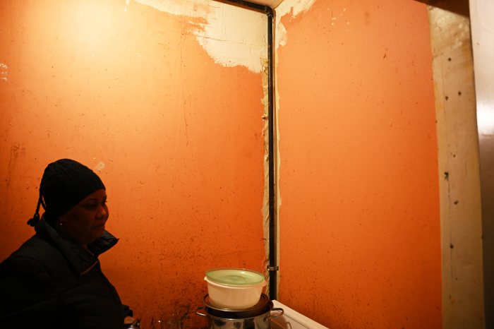 tenant with chipped wall paint in apartment