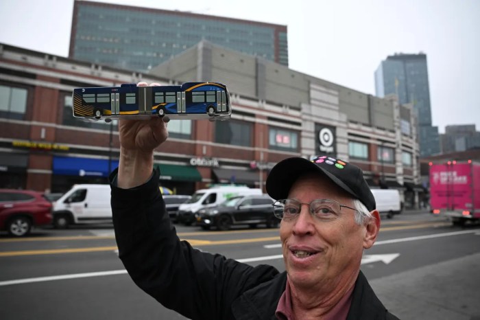 rallygoer with bus model on flatbush avenue