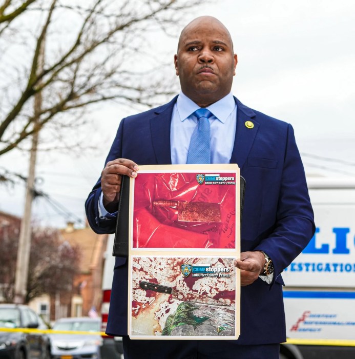 police officer holding photo of bloody machete