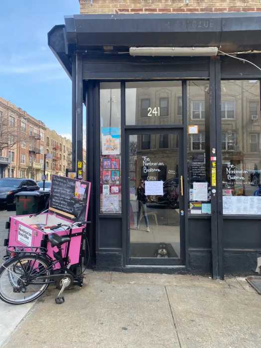 nonbinarian book bike outside bookstore