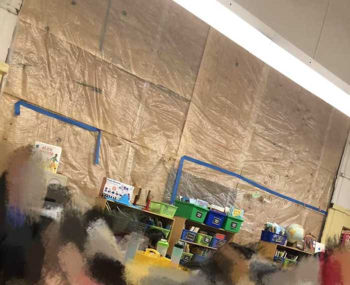 classroom with tarps taped over windows