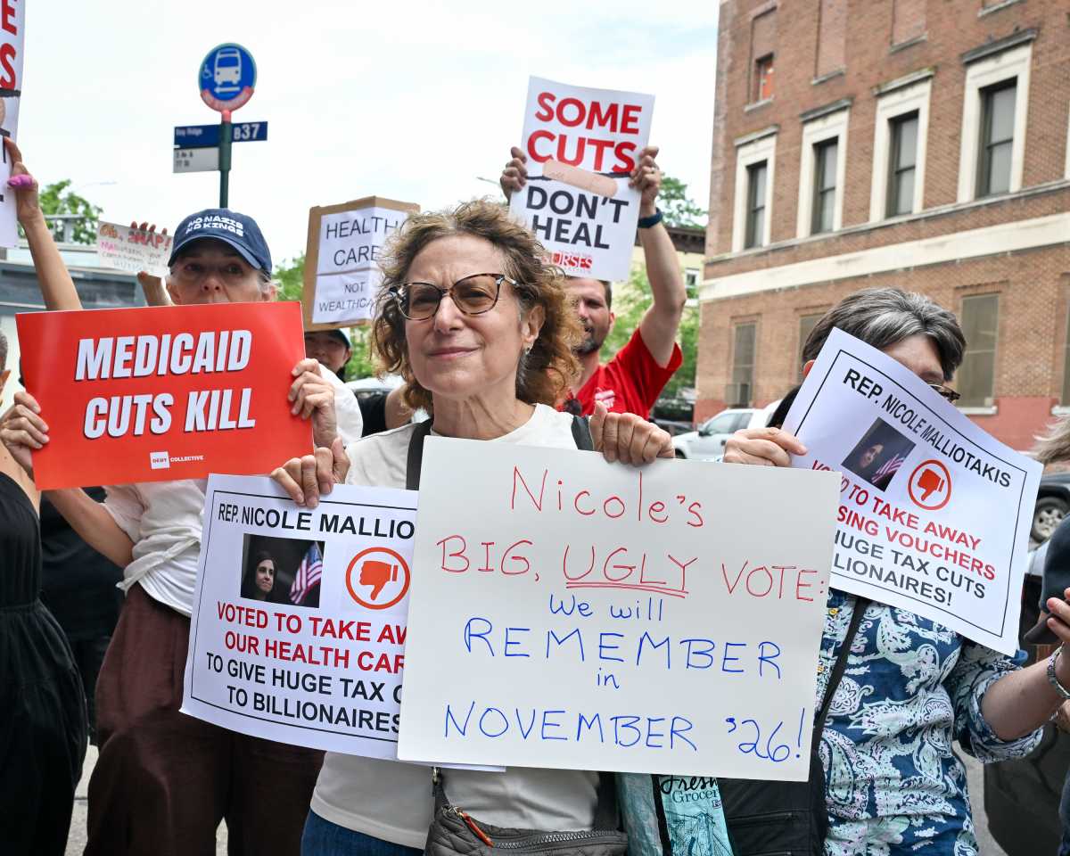 protestors rally outside malliotakis office holding signs against healthcare cuts