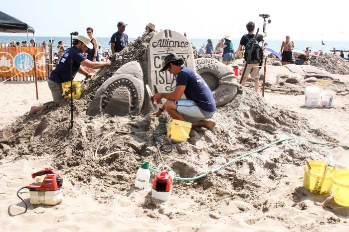 people sculpting at sand sculpting contest